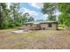 Expansive backyard with a wooden deck and brick patio area, providing ample space for outdoor activities at 3640 Se 131St Ln, Belleview, FL 34420