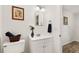 Cozy bathroom features vanity sink with a framed mirror and decorative accents at 3640 Se 131St Ln, Belleview, FL 34420
