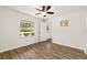 This bedroom offers a ceiling fan and natural light with a calming backyard view at 3640 Se 131St Ln, Belleview, FL 34420