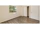 Bedroom features a window with a wooded view and a closet with sliding doors at 3640 Se 131St Ln, Belleview, FL 34420