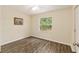 Bedroom with a ceiling fan, natural light, and wood-look flooring at 3640 Se 131St Ln, Belleview, FL 34420