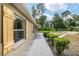 Home exterior featuring a concrete walkway and well-manicured bushes with decorative window shutters at 3640 Se 131St Ln, Belleview, FL 34420