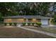 Well-maintained home exterior with manicured bushes, decorative shutters, and an inviting walkway at 3640 Se 131St Ln, Belleview, FL 34420