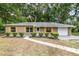 Charming single-story home featuring manicured landscaping and a well-maintained front yard at 3640 Se 131St Ln, Belleview, FL 34420