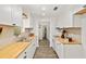 Galley kitchen featuring new white cabinetry and butcher block countertops at 3640 Se 131St Ln, Belleview, FL 34420