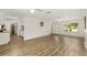 Bright living room featuring hardwood floors, access to kitchen and exit door at 3640 Se 131St Ln, Belleview, FL 34420