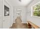 Mud room with wooden bench, coat hooks, and a view into the living room at 3640 Se 131St Ln, Belleview, FL 34420