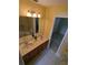 Bathroom features a double sink vanity, decorative lighting, and a shower-tub combo at 3650 Se 55Th Ct, Ocala, FL 34480