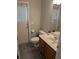 Bathroom with a single sink vanity, a toilet, and a door leading to the outside at 3650 Se 55Th Ct, Ocala, FL 34480