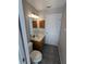 Bathroom with a single sink vanity, a toilet, tiled flooring, and a medicine cabinet at 3650 Se 55Th Ct, Ocala, FL 34480