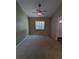 Inviting bedroom featuring neutral carpet, a ceiling fan, and a bright window for plenty of natural light at 3650 Se 55Th Ct, Ocala, FL 34480