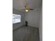 Bedroom features white walls, green carpet, ceiling fan, and a small window at 3650 Se 55Th Ct, Ocala, FL 34480