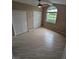 Bedroom features neutral walls, updated flooring, a double window, and double door closets at 3650 Se 55Th Ct, Ocala, FL 34480