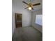 Bedroom features white walls, gray carpet, ceiling fan, and a small window with blinds at 3650 Se 55Th Ct, Ocala, FL 34480