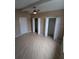 Neutral bedroom features a ceiling fan, updated flooring, standard closet, and walk-in closet at 3650 Se 55Th Ct, Ocala, FL 34480
