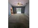 Carpeted bedroom with pool views through sliding glass doors and ensuite bathroom access at 3650 Se 55Th Ct, Ocala, FL 34480