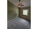 Cozy bedroom with neutral carpet, a ceiling fan, and a bright window creating a peaceful retreat at 3650 Se 55Th Ct, Ocala, FL 34480