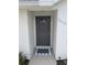 Stylish front door with a welcome mat, enhancing the home's curb appeal at 3650 Se 55Th Ct, Ocala, FL 34480