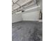 Spacious garage interior with concrete floor, painted walls, and overhead lighting with mechanicals along back wall at 3650 Se 55Th Ct, Ocala, FL 34480