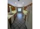 Galley kitchen features ample counter space, wooden cabinets, and essential appliances at 3650 Se 55Th Ct, Ocala, FL 34480