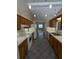 Galley kitchen featuring wooden cabinetry, white appliances, and tile flooring at 3650 Se 55Th Ct, Ocala, FL 34480