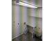The laundry room features tile flooring, white cabinets and a utility sink at 3650 Se 55Th Ct, Ocala, FL 34480