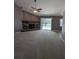 Bright living room featuring a brick fireplace, vaulted ceiling, and sliding glass door access to the pool at 3650 Se 55Th Ct, Ocala, FL 34480