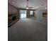 Spacious living room with fireplace, sliding glass door, and pass-through to the kitchen, perfect for entertaining at 3650 Se 55Th Ct, Ocala, FL 34480