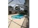 Screened-in pool is surrounded by a large patio and lush landscaping at 3650 Se 55Th Ct, Ocala, FL 34480