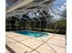 Screened-in pool surrounded by a large patio and lush landscaping at 3650 Se 55Th Ct, Ocala, FL 34480