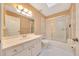 Bathroom features a vanity sink, white cabinetry, a large mirror, and a shower over tub at 3769 Grove View Ln, Port Orange, FL 32129