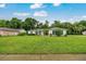 Charming single-story home featuring a large front yard, mature landscaping, and a welcoming front entrance at 3769 Grove View Ln, Port Orange, FL 32129