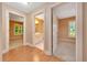 Hallway view showcasing an en suite bathroom, bedroom, and wood flooring at 3769 Grove View Ln, Port Orange, FL 32129