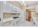 Modern kitchen with white cabinetry, updated appliances, and a decorative backsplash at 3769 Grove View Ln, Port Orange, FL 32129
