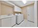 Laundry room with washer, dryer, cabinetry, shelving, and utility sink at 3769 Grove View Ln, Port Orange, FL 32129