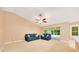 Comfortable living room with neutral carpet, slider doors, and furniture perfect for relaxing and entertaining at 3769 Grove View Ln, Port Orange, FL 32129
