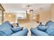 Spacious living area featuring neutral colors, ceiling fan, and modern lighting above the kitchen counter at 3769 Grove View Ln, Port Orange, FL 32129