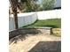 Brick patio and stone seating area in a well-kept backyard with grass and privacy fence at 3983 Sw 51St Ct, Ocala, FL 34474