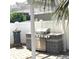 Outdoor kitchen with a stainless steel grill, tiled counters, and a shade pergola at 3983 Sw 51St Ct, Ocala, FL 34474