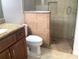 Bathroom featuring a vanity with granite countertops, a toilet, and a shower stall with glass door at 3983 Sw 51St Ct, Ocala, FL 34474
