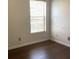 Bedroom with dark floors, white walls and a window with blinds at 3983 Sw 51St Ct, Ocala, FL 34474