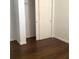 Bedroom features hardwood flooring, white walls, and a sliding door closet at 3983 Sw 51St Ct, Ocala, FL 34474