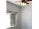 Bright bedroom featuring a ceiling fan, a window with vertical blinds, and neutral walls at 3983 Sw 51St Ct, Ocala, FL 34474