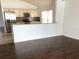 Open-concept kitchen featuring granite counters, stainless appliances, tile backsplash, and wood flooring at 3983 Sw 51St Ct, Ocala, FL 34474