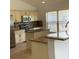Kitchen featuring granite countertops, a kitchen island, and a breakfast bar at 3983 Sw 51St Ct, Ocala, FL 34474