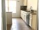 Bright kitchen with neutral cabinets, granite countertops, stainless steel appliances, and tile flooring at 3983 Sw 51St Ct, Ocala, FL 34474