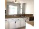 Bright kitchen with granite countertops, modern cabinets, and stainless steel faucet at 3983 Sw 51St Ct, Ocala, FL 34474