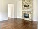 Open-concept living room with hardwood floors and decorative stone fireplace at 3983 Sw 51St Ct, Ocala, FL 34474