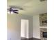 Living room featuring a stone fireplace, ceiling fan and neutral walls at 3983 Sw 51St Ct, Ocala, FL 34474