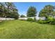 Large backyard with lush green lawn and white fence offers plenty of room for outdoor activities at 4360 Se 106Th St, Belleview, FL 34420